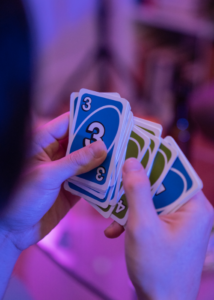 person holding group of Uno cards