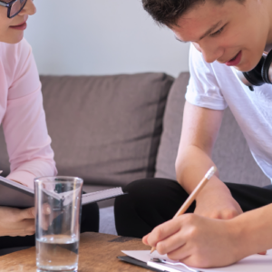 adult helping youth with homework