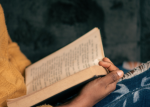 child holding book in lap